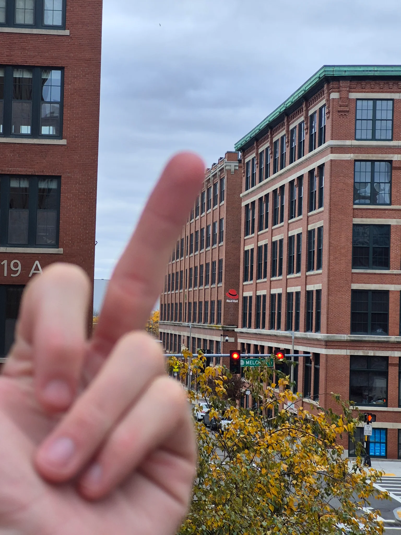 transgender shitposter flips off the redhat building